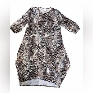 Zadie B’s Elegant Animal Print High Low Dress with ballooned handkerchief hem.